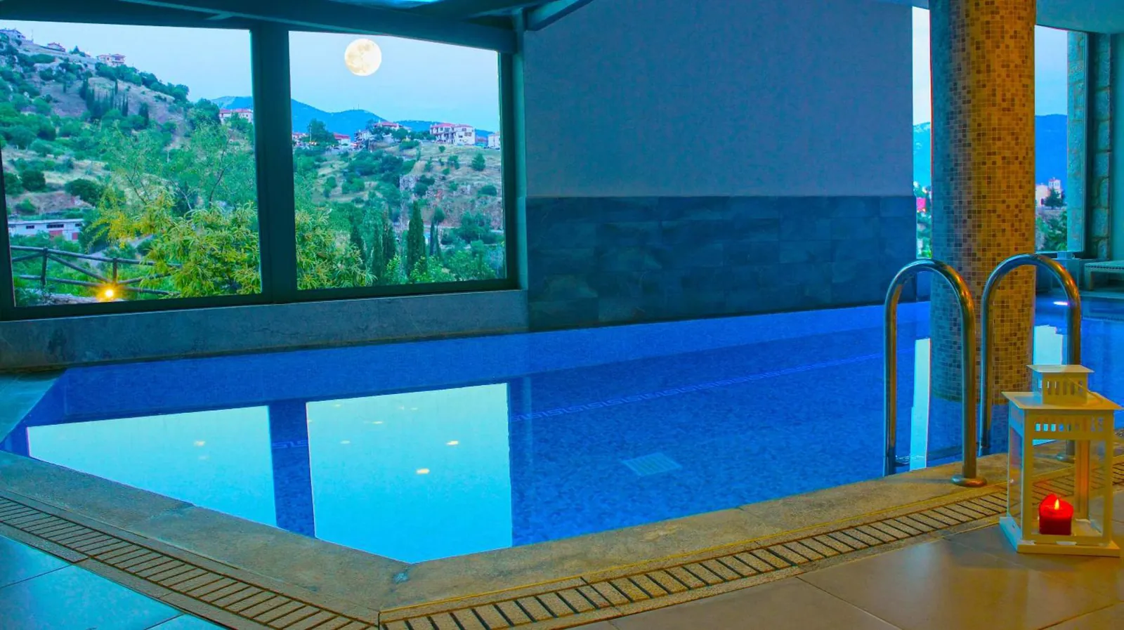 Indoor pool with a window onto the village and hillside