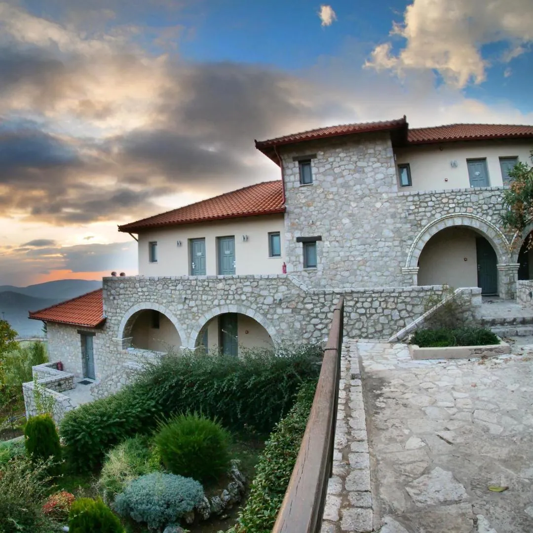 Stone hotel building with arches and a terracotta roof