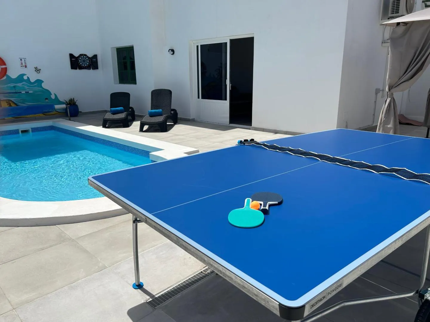 Table tennis table set up beside the private pool
