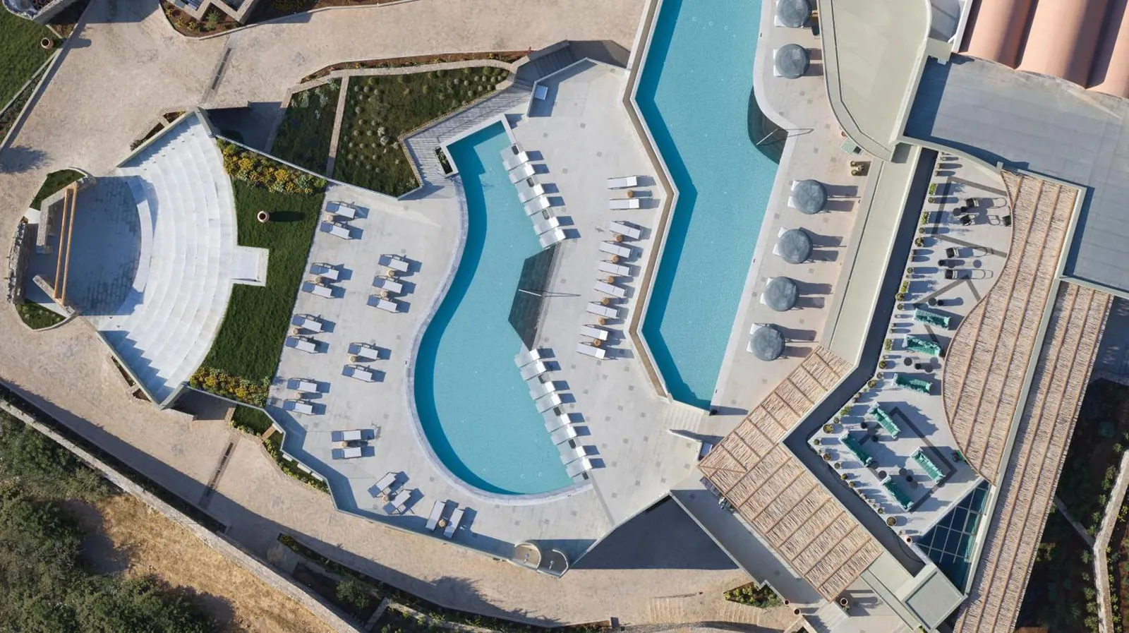 Aerial view of the curving outdoor pools and rows of loungers