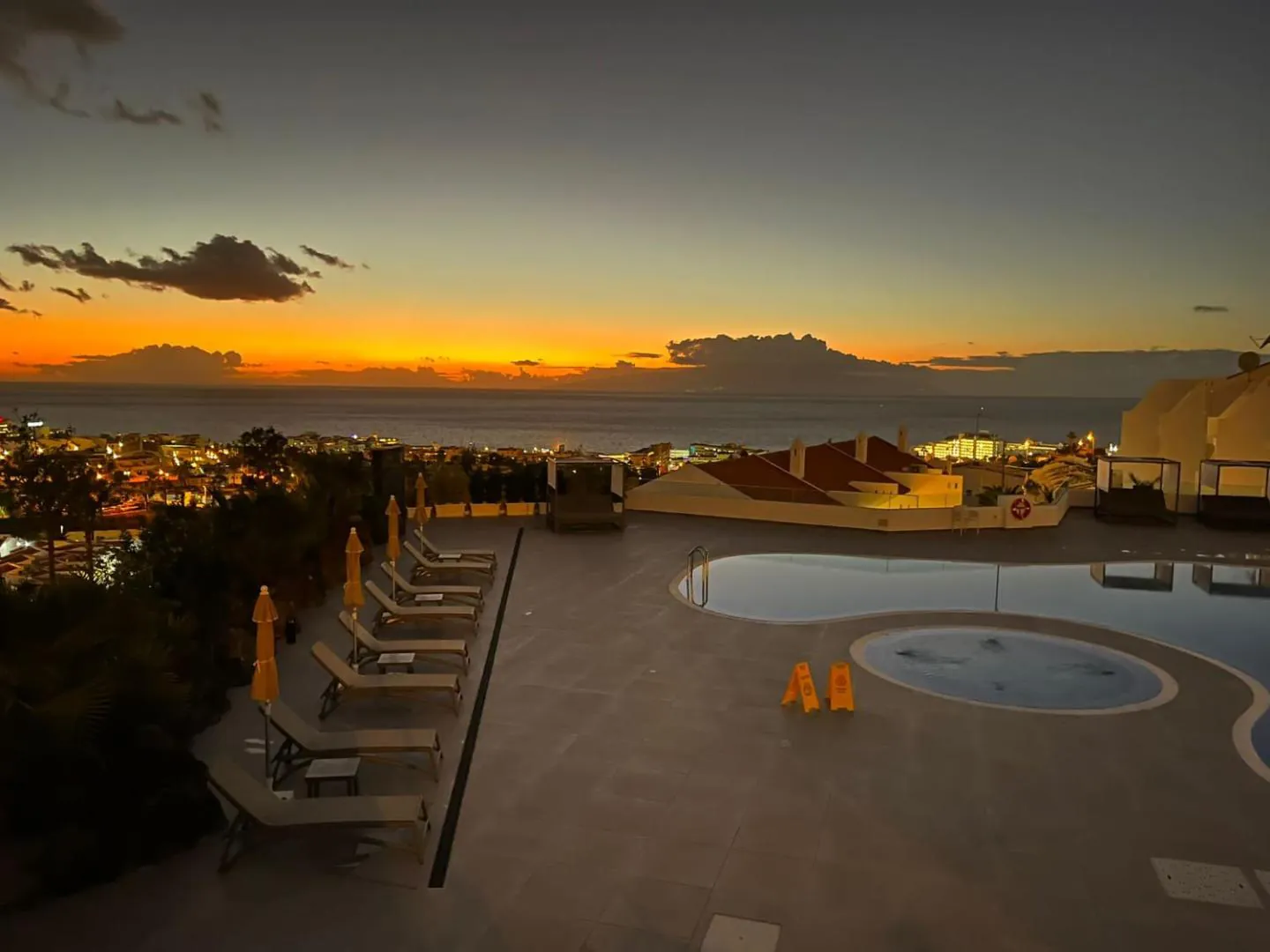 Pool terrace at sunset above the lights of Costa Adeje