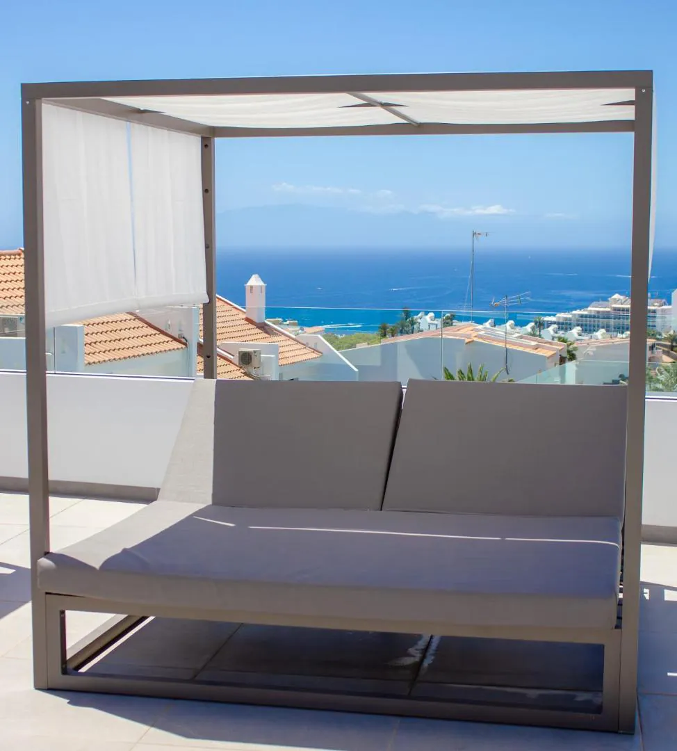Canopy daybed on the pool terrace facing the sea