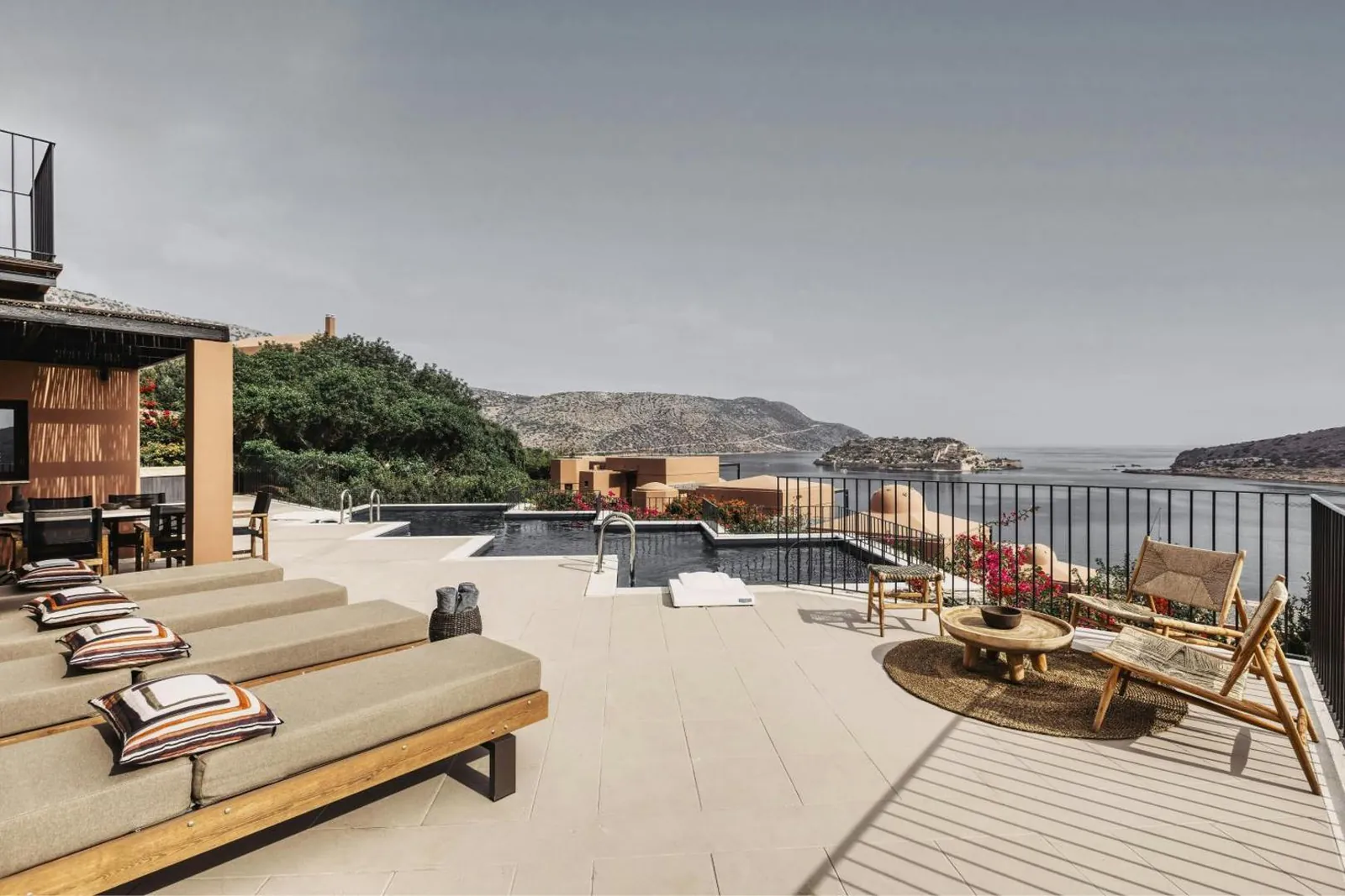 Residence terrace with a private pool, loungers and views over the bay