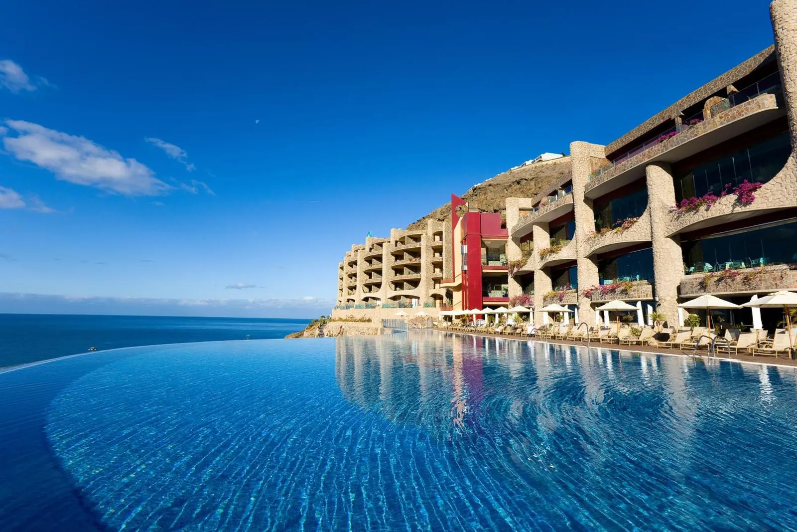 Infinity pool at Gloria Palace Royal running out to the Atlantic, the stepped hotel above