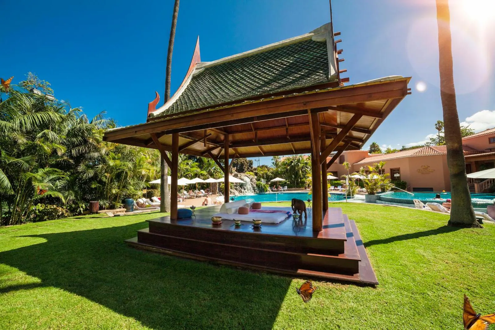 Garden pavilion on the lawn beside the pool