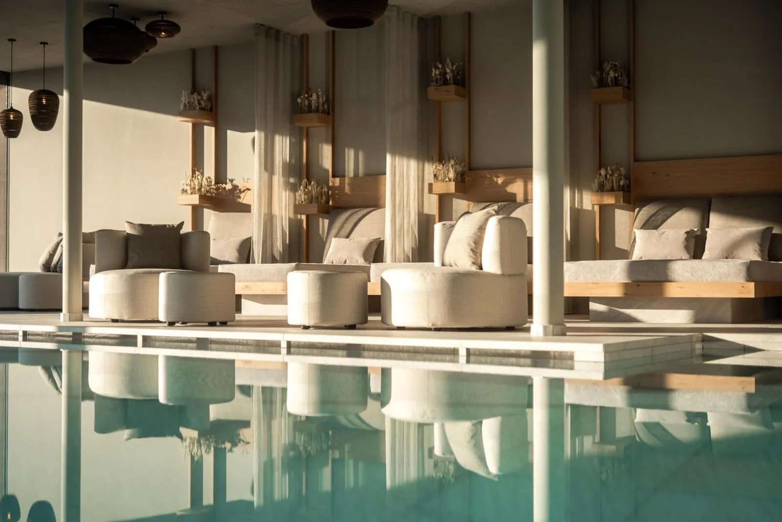 The indoor pool in the vitality centre with loungers along the glass wall