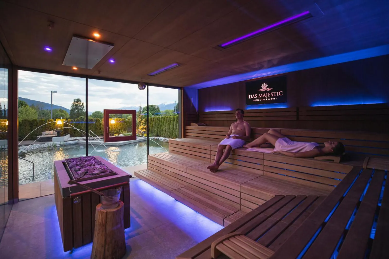 Sauna with a panoramic window and blue accent lighting