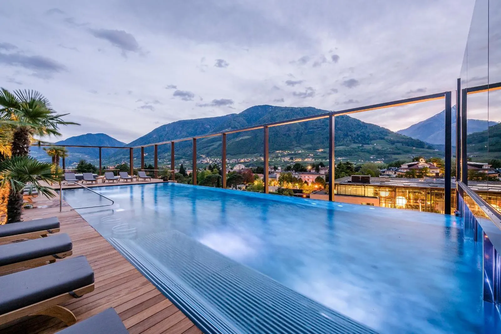 Rooftop infinity pool at Hotel Therme Meran looking across Merano to the mountains