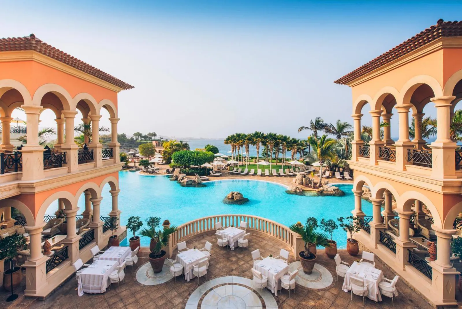 The outdoor pool running between the two arcaded wings of JOIA El Mirador by Iberostar