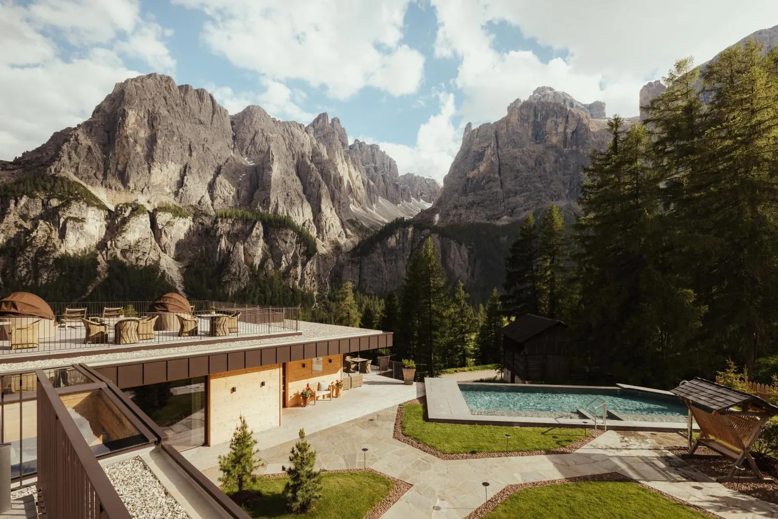 Outdoor pool and garden in summer below the rock walls
