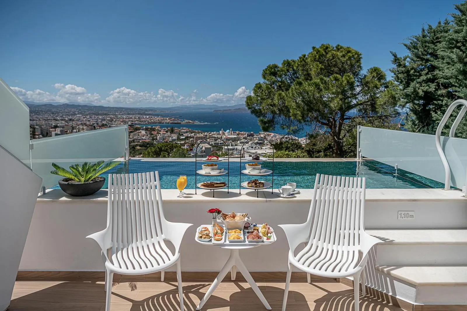Private pool and breakfast table on a terrace above Chania and the bay
