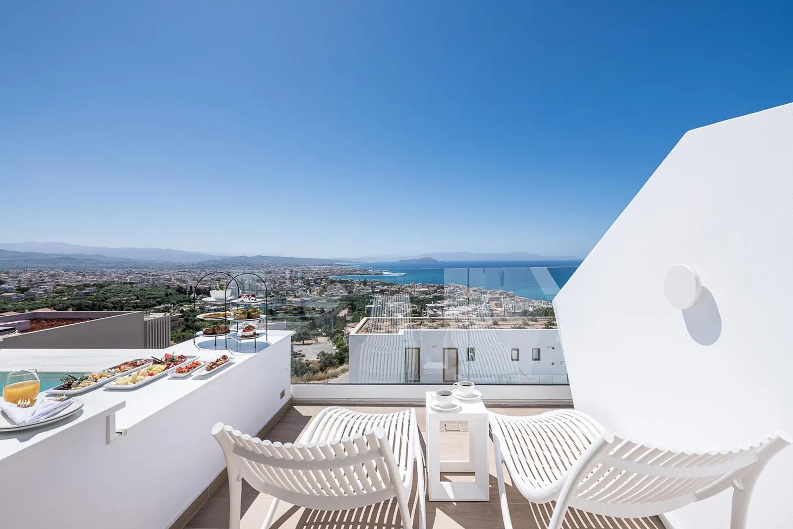 Terrace with loungers and a private pool looking over the rooftops of Chania