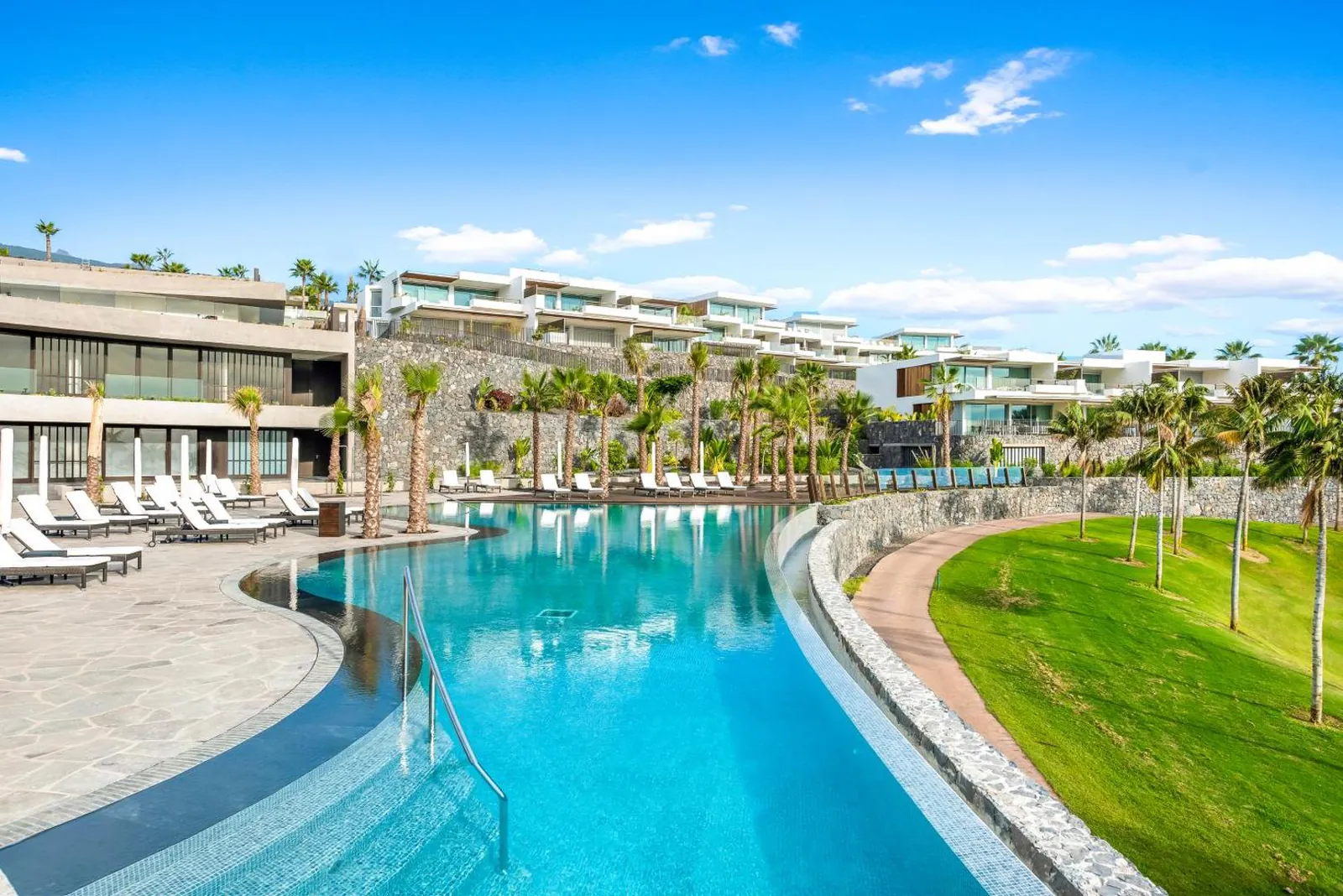 Long curving pool below the terraced suite buildings