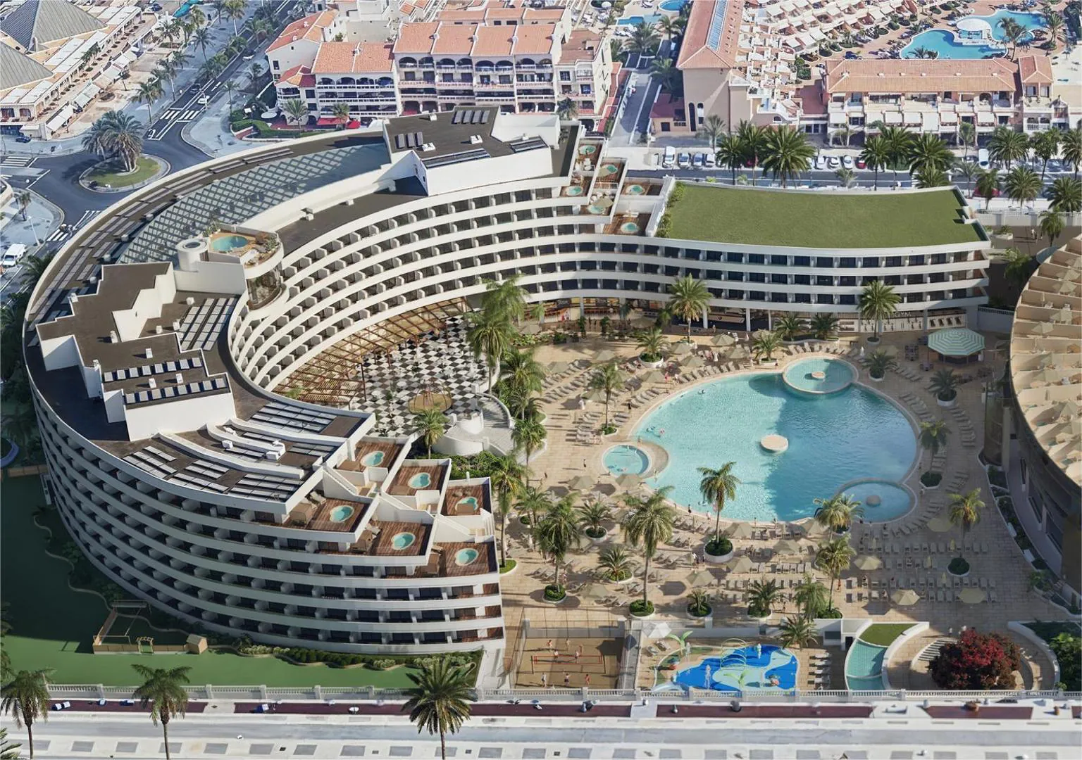 Aerial view of the round hotel wrapped around its pool garden