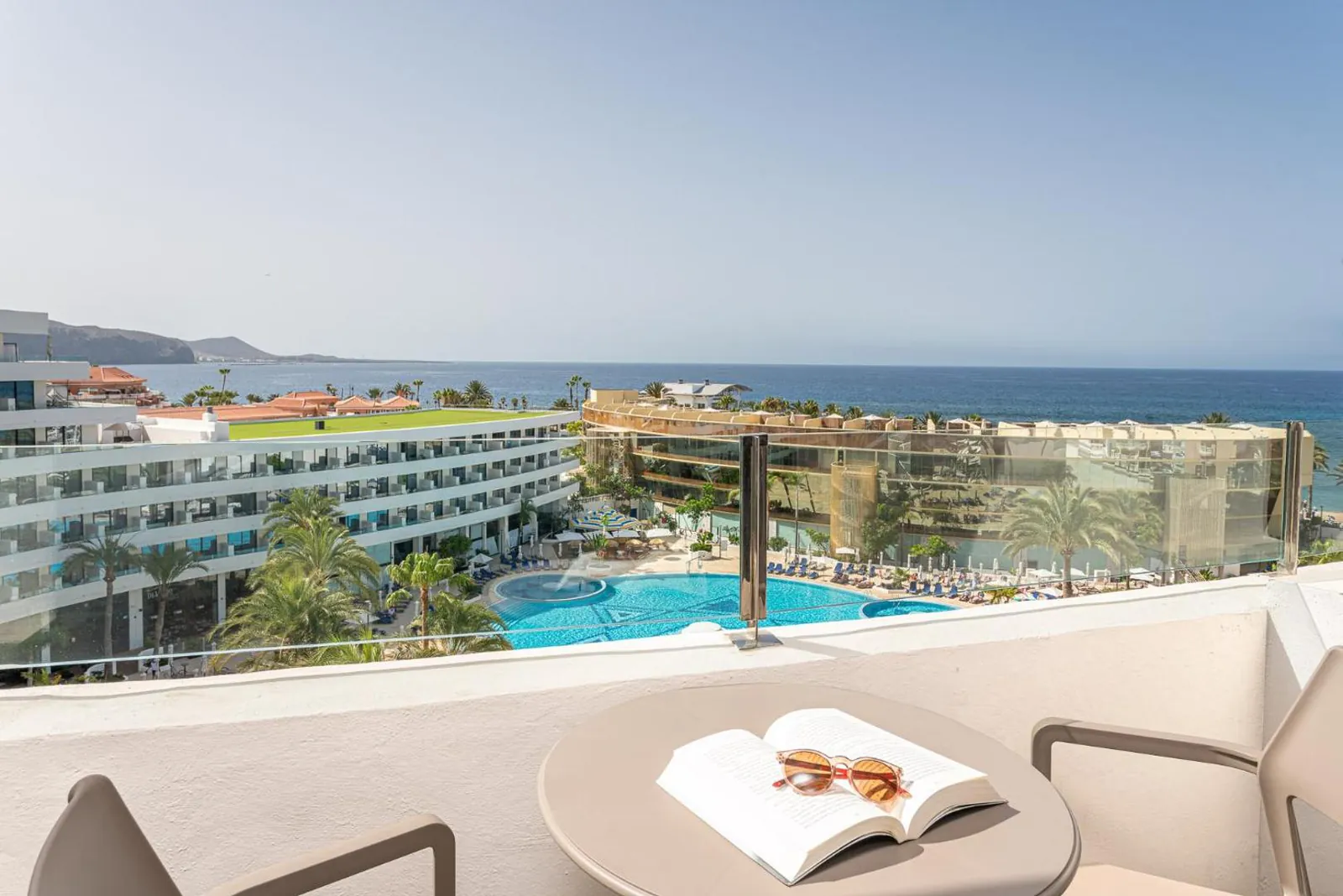 Room balcony looking over the pool garden to the sea