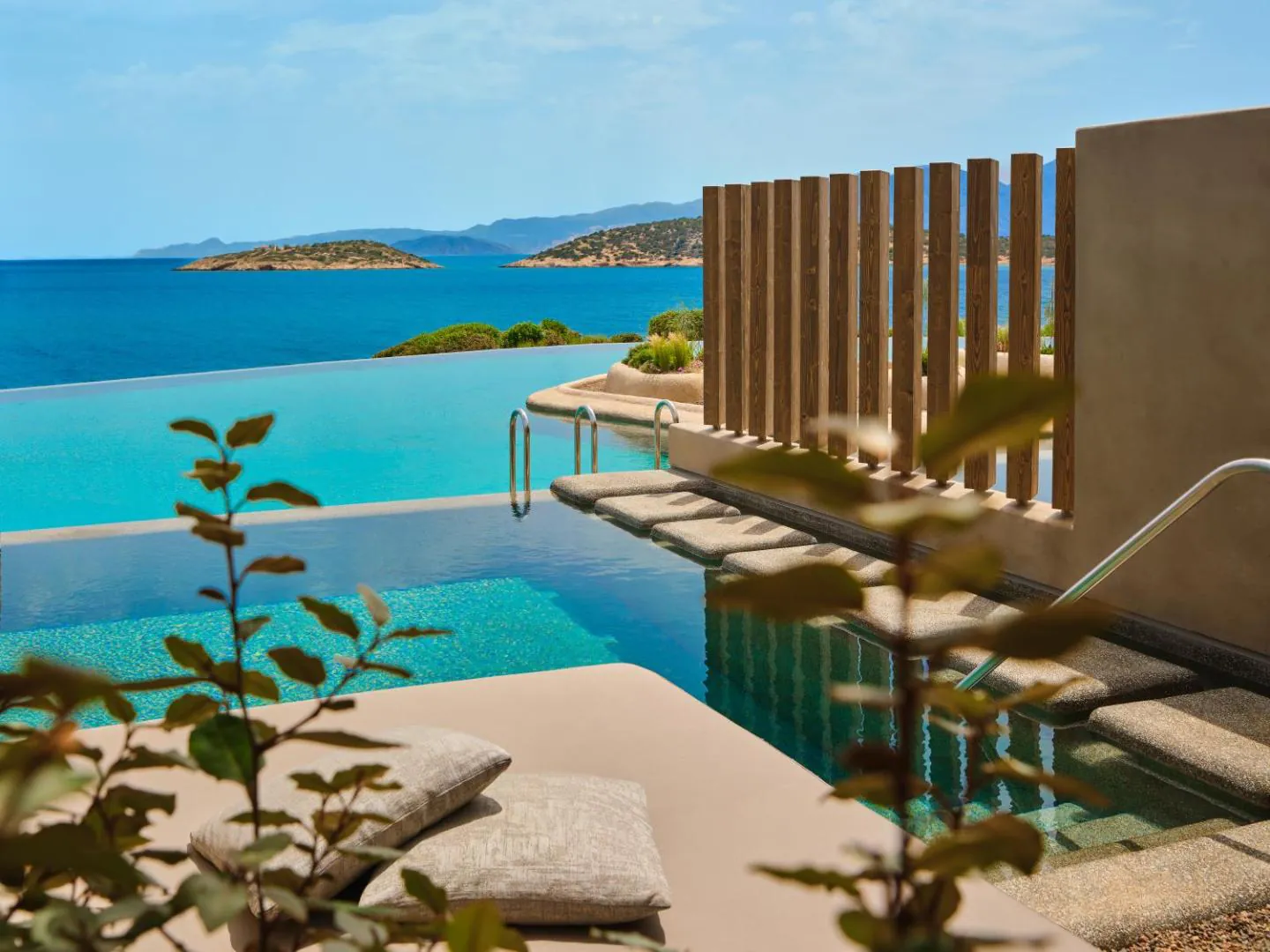 Infinity pool with in-water loungers overlooking Mirabello Bay and its islets at Minos Palace