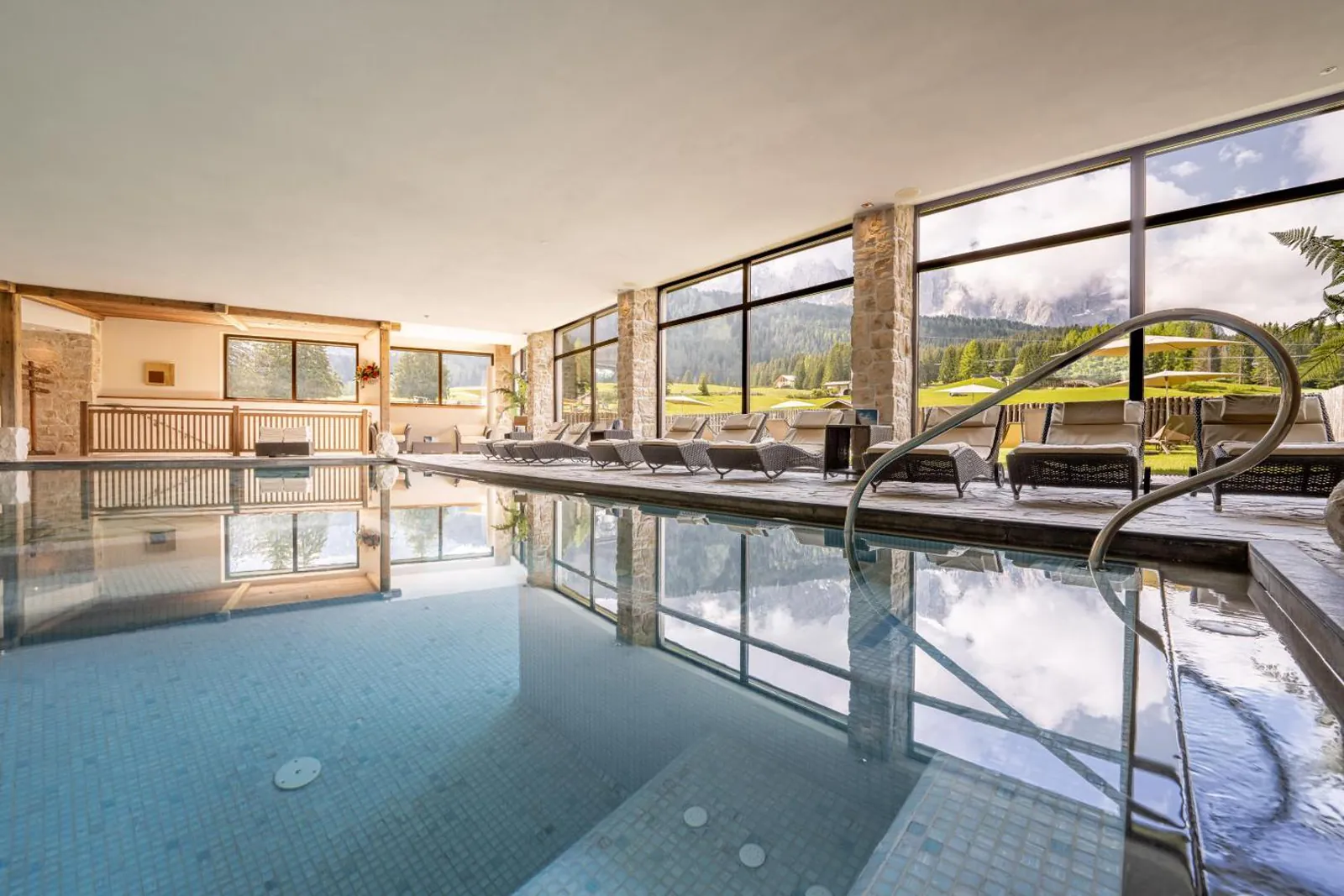 Indoor pool and sun terrace at Monte Pana Dolomites Hotel, Santa Cristina