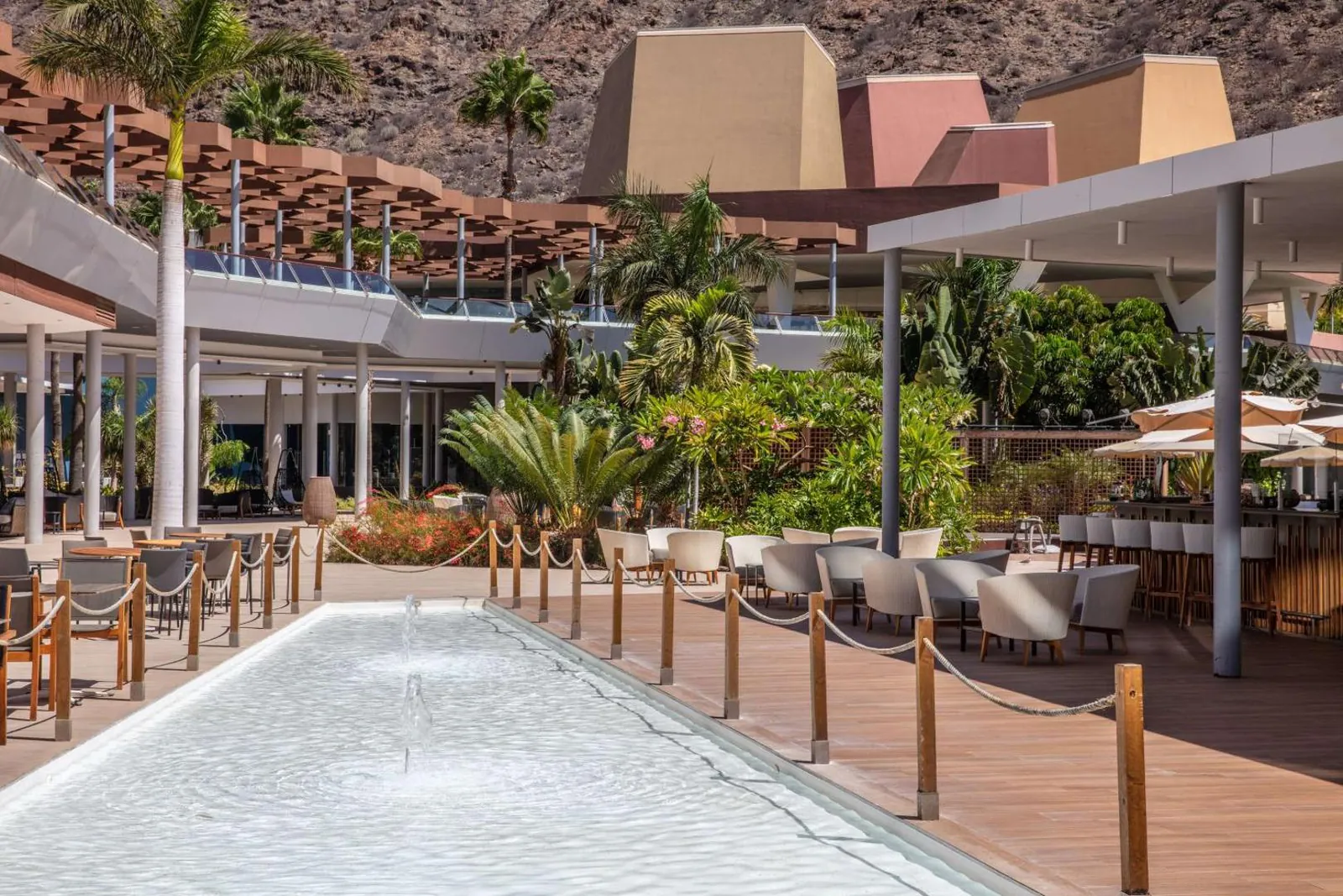 Terrace bar beside a shallow water feature under the palms