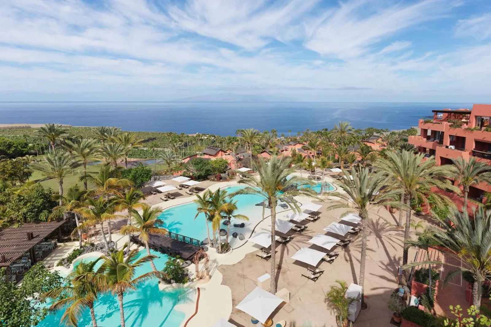 Lagoon-style pool winding between palms and sun loungers at The Ritz-Carlton Tenerife, Abama
