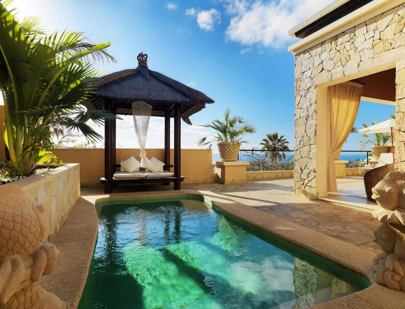 Private pool beside a stone and timber gazebo at Royal Garden Villas