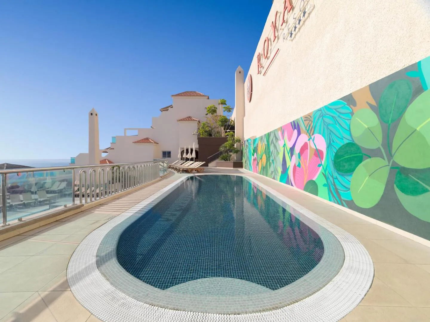 Second, smaller pool beside a painted mural at Royal Sun Resort
