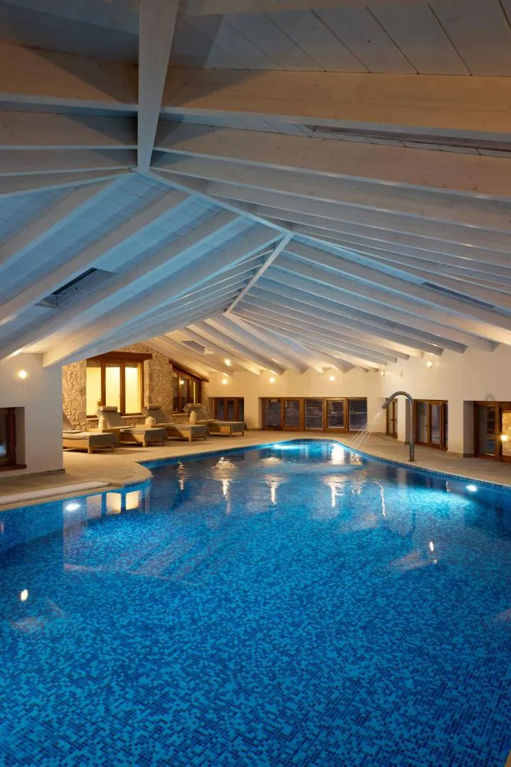 Indoor pool seen from the end under the pitched ceiling