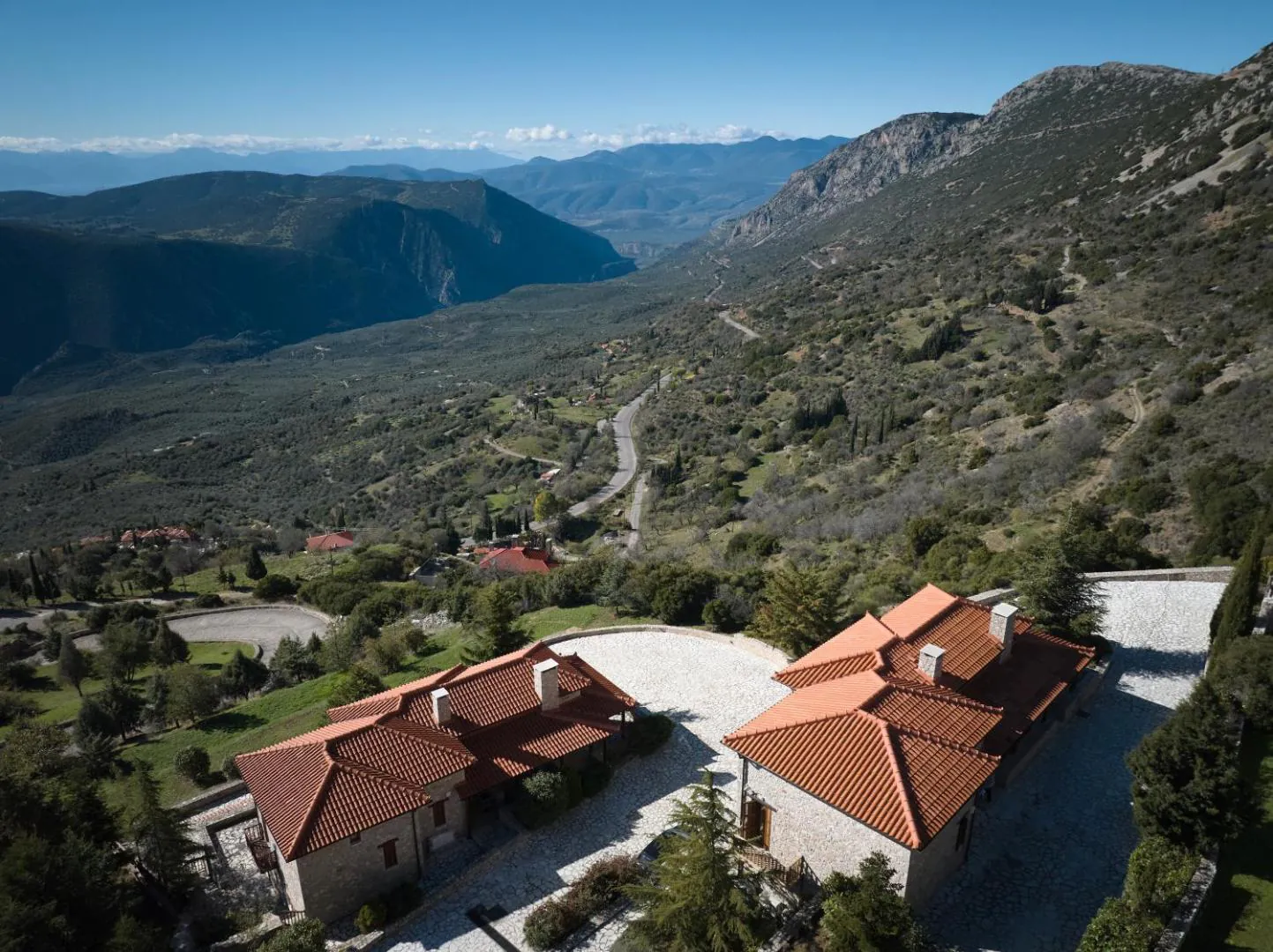 Aerial view of the resort roofs among trees in the Parnassos valley