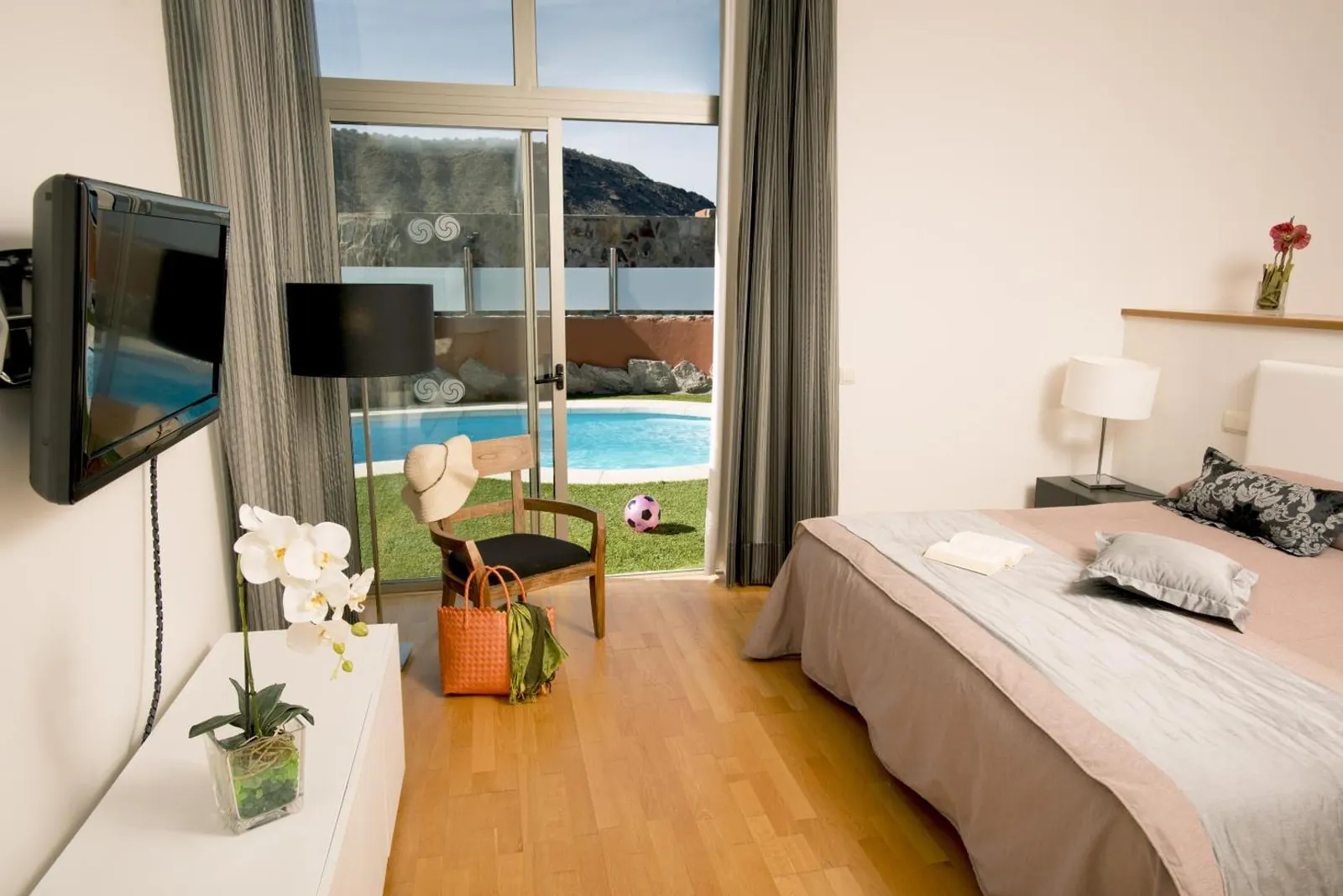Bedroom with glass doors looking onto the private pool