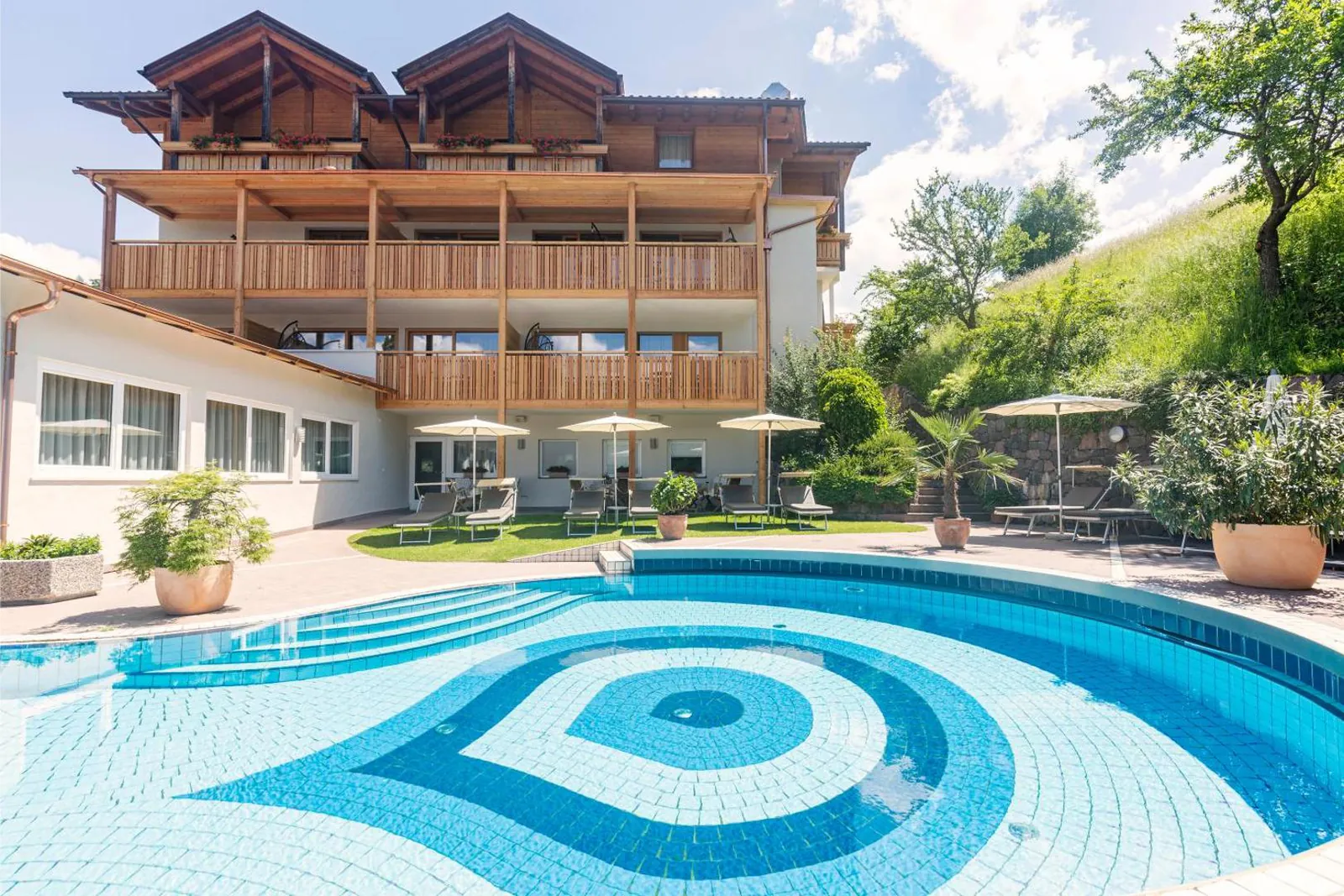 Tiled outdoor pool below the hotel's wooden balconies
